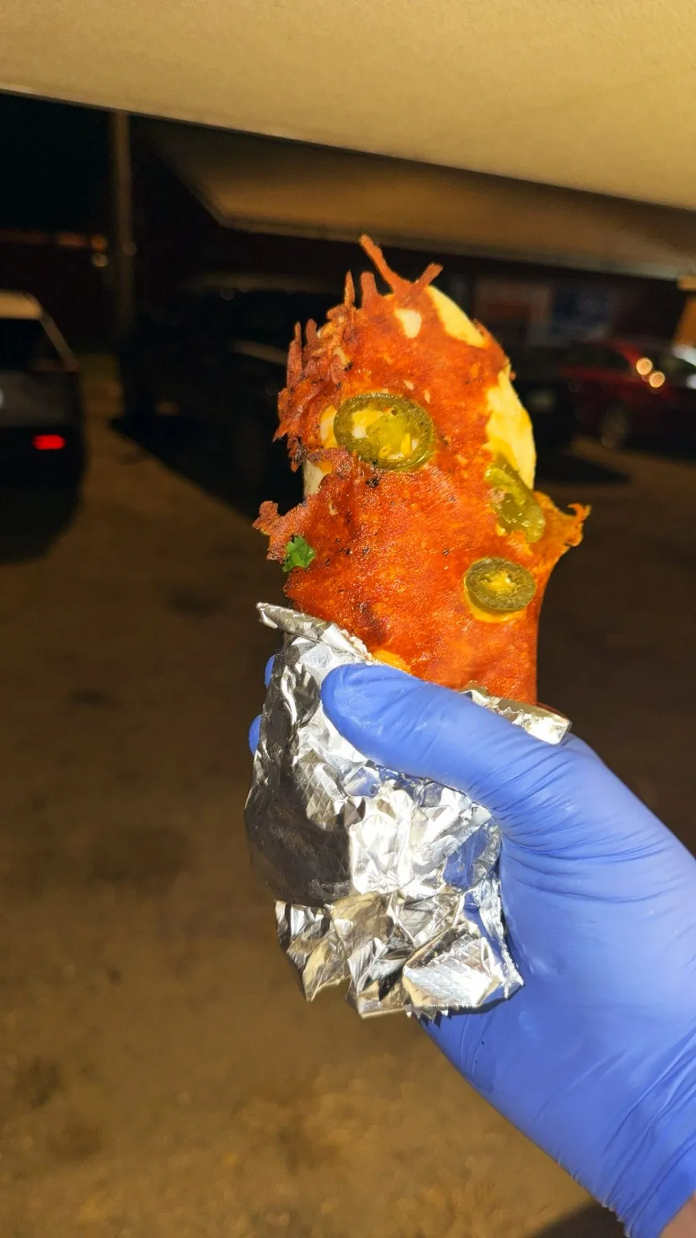 A taquito topped with salsa and jalapeños at a night service